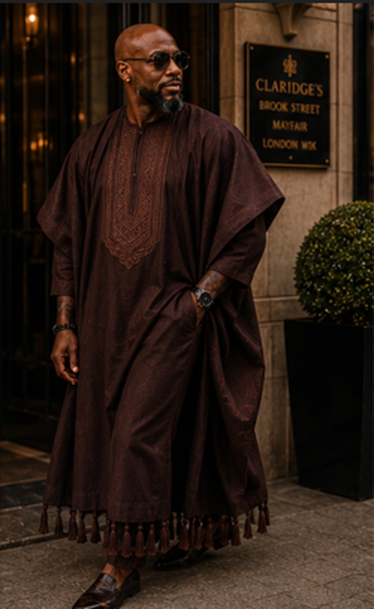 A deep brown agbada with tonal embroidery and matching fila worn in Mayfair