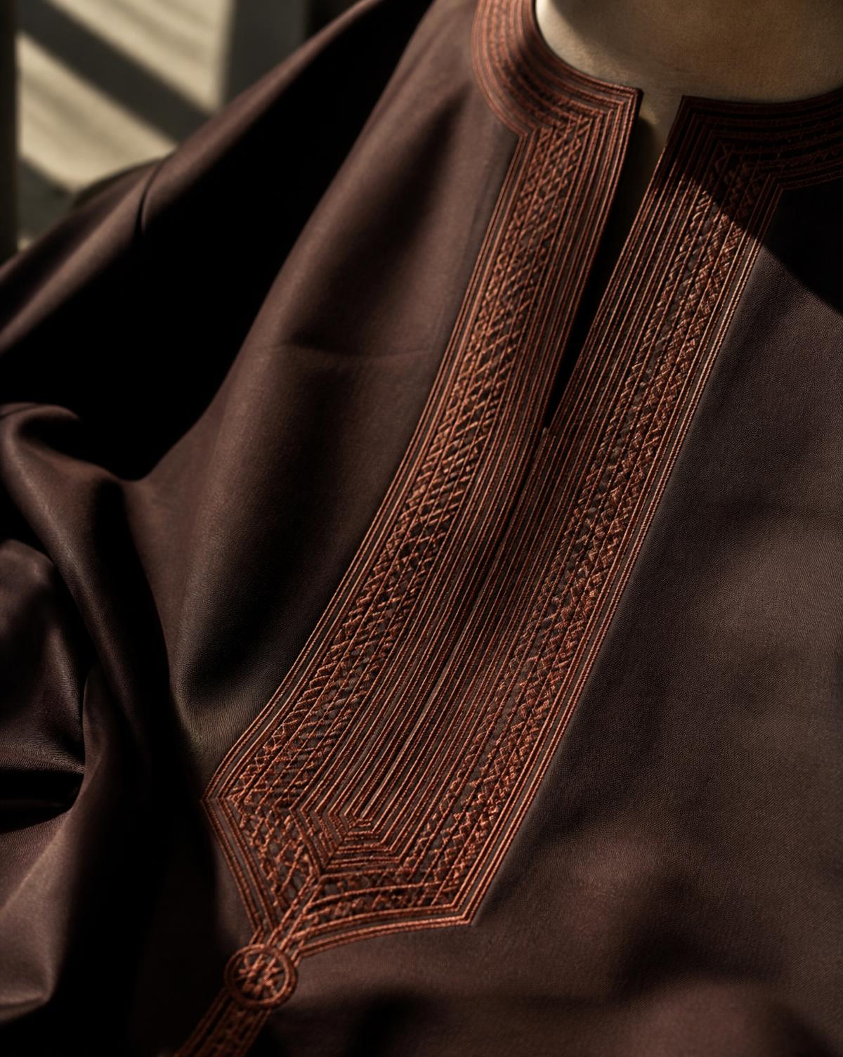 Hand-embroidered agbada neckline in espresso cloth — the finish I look for at Soboye
