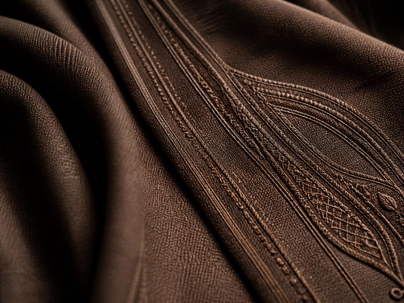 Macro detail of the brown agbada cloth and tonal embroidery