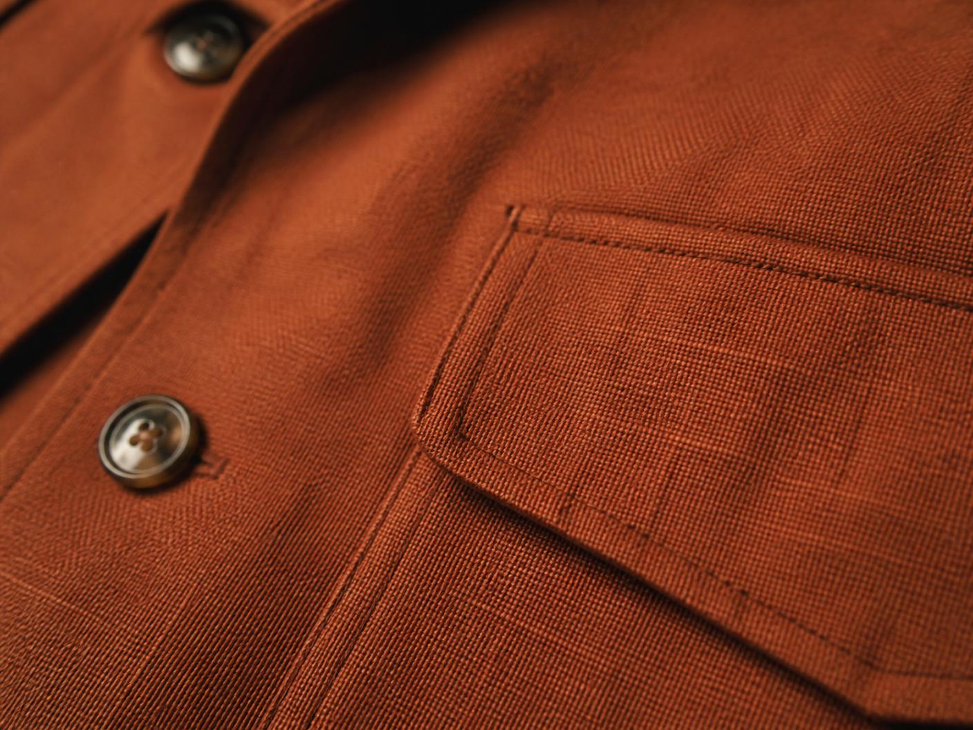 Macro detail of the rust safari suit cloth and stitching